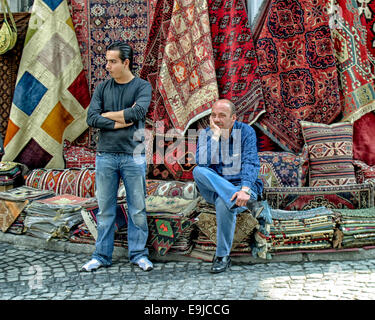 Istanbul, Turkey. 2nd Oct, 2004. Two rug merchants wait for customers besides their wares near the Grand Bazaar in Istanbul, Turkey. © Arnold Drapkin/ZUMA Wire/Alamy Live News Stock Photo