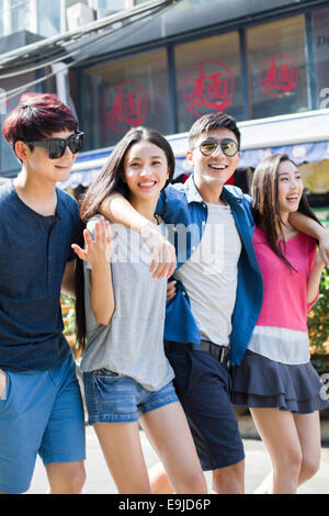 Young friends walking together on street Stock Photo