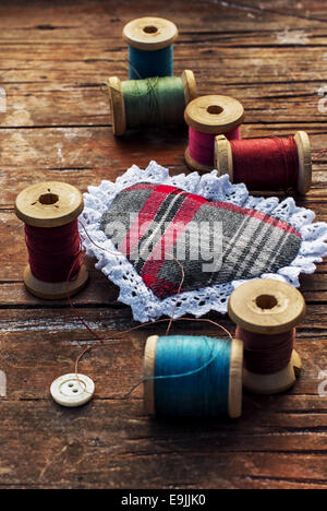 set of threads of different types,colors and lengths on wooden background Stock Photo
