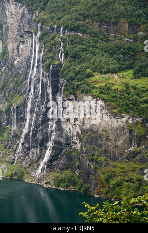 Knivsflå farm sitting about 250 meters above the fjord next to the Seven Sisters waterfall in Geiranger fjord, Norway. Stock Photo