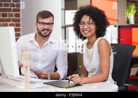 Smiling photo editors in office Stock Photo