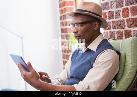 Concentrated man using digital tablet Stock Photo