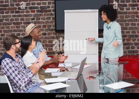 Young business team clapping hands in meeting Stock Photo