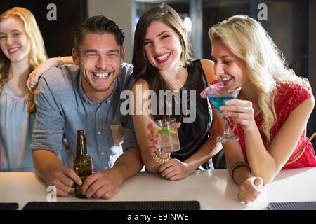 Happy friends having a drink together Stock Photo