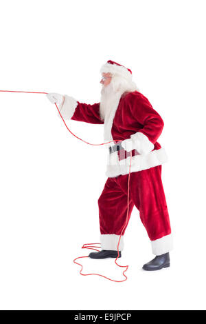 Santa pulls something with a rope Stock Photo