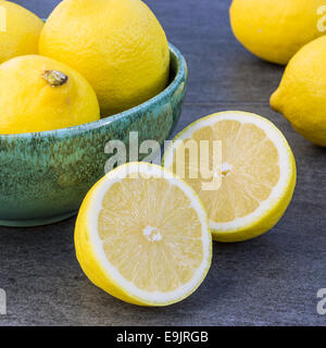 Green bowl with lemons Stock Photo