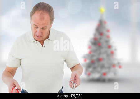 Composite image of man looking in shopping bags Stock Photo
