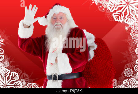 Composite image of santa claus waving Stock Photo