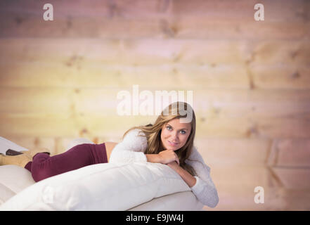 Composite image of pretty blonde relaxing on the couch Stock Photo