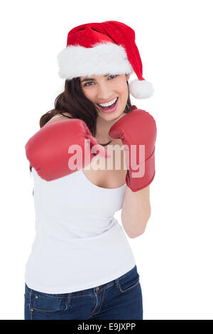 Festive brunette in boxing gloves punching Stock Photo