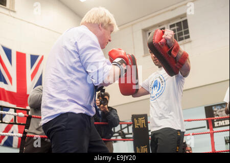 Newham, London, UK. 28th October 2014. Boris Johnson visits a training session at the Fight for Peace Academy in Newham. Fight for Peace uses boxing and martial arts combined with education and personal development to realise the potential of young people in the borough at risk of crime and violence. First established in Rio in 2000 by Luke Dowdney MBE, it was replicated in Newham in 2007. It is now expanding globally and began rolling out across the UK in May 2014. Credit:  Lee Thomas/Alamy Live News Stock Photo