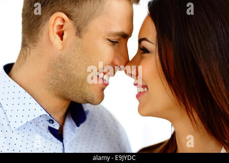 Happy young couple looking at each other over white background Stock Photo