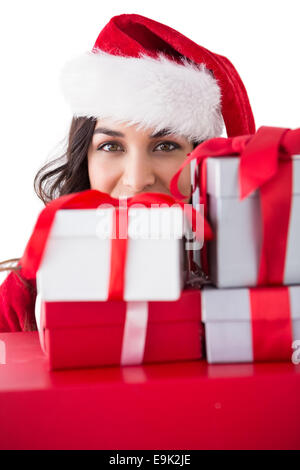 Festive brunette holding stack of gifts Stock Photo
