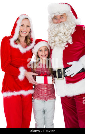Santa and Mrs Claus smiling at camera with little girl Stock Photo