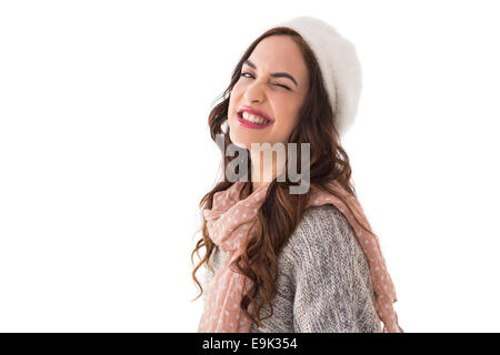 Brunette in winter clothes winking her eye Stock Photo