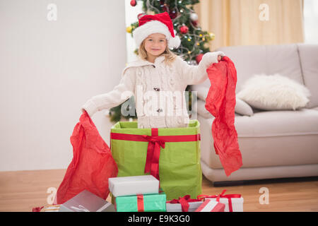 Cute little girl sitting in giant christmas gift Stock Photo