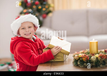 Festive little boy opening a gift Stock Photo