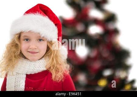 Festive little girl in santa hat and scarf Stock Photo