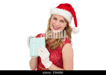 Smiling blonde in red dress wearing gloves and santa hat Stock Photo