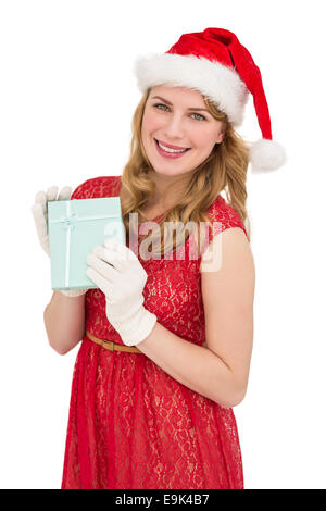 Smiling blonde in red dress wearing gloves and santa hat Stock Photo