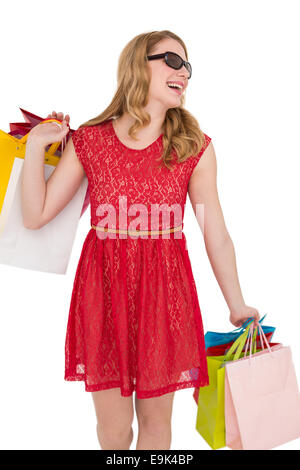 Woman holding shopping bags wearing sunglasses Stock Photo