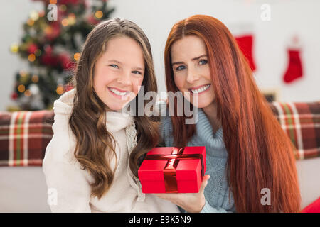 Daughter giving her mother a christmas present Stock Photo