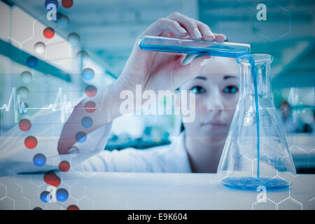 Composite image of scientist pouring a liquid in an erlenmeyer flask with a test tube Stock Photo
