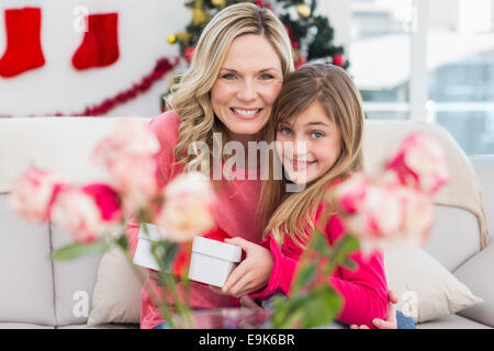 Little girl giving her mother a christmas gift Stock Photo