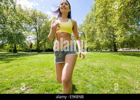 https://l450v.alamy.com/450v/e9k8nb/young-fit-woman-jogging-at-park-e9k8nb.jpg