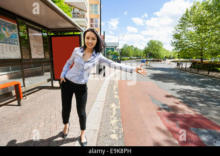 Full length beautiful businesswoman hailing taxi on street Stock Photo