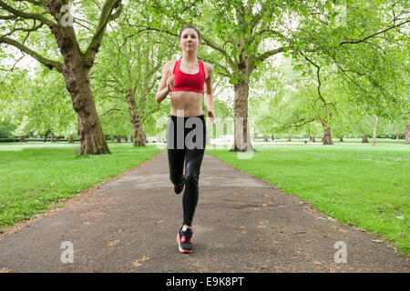 Full length of fit young woman jogging in park Stock Photo