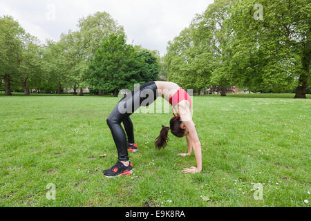 Full length side view of fit woman exercising in park