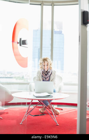 Creative businesswoman using laptop in office Stock Photo