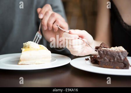 Cropped image of couple having pastries Stock Photo