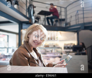 Portrait of smiling young woman using tablet PC in cafe Stock Photo