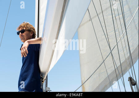 Side view of middle-aged man on yacht Stock Photo