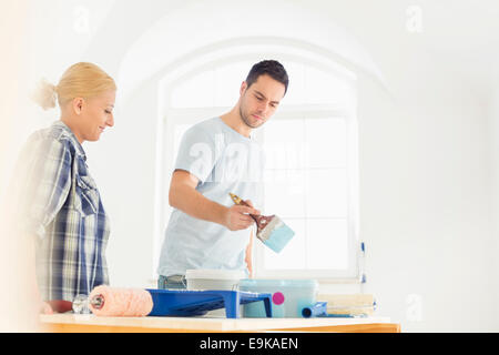 Mid-adult couple painting in new house Stock Photo