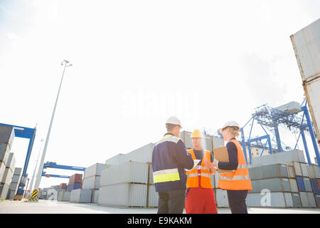 Workers talking in shipping yard Stock Photo