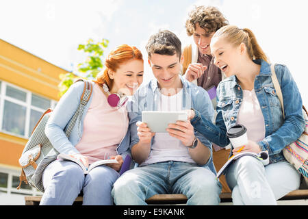 Young students using digital tablet at college campus Stock Photo
