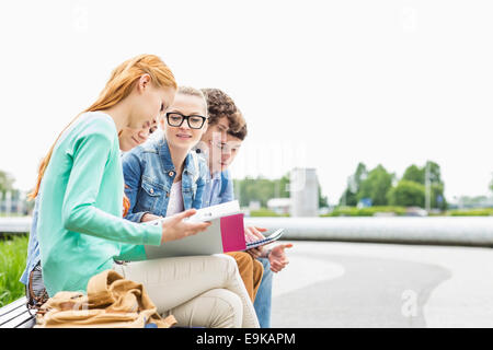 University students studying together at park Stock Photo