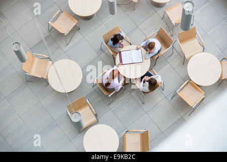 High angle view of businesswomen doing paperwork in office canteen Stock Photo