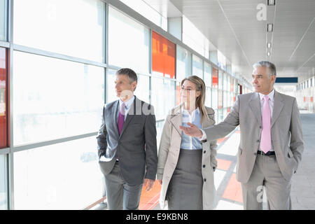 Business colleagues walking on train platform Stock Photo