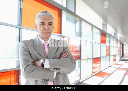 Portrait of confident middle aged businessman at railroad station Stock Photo