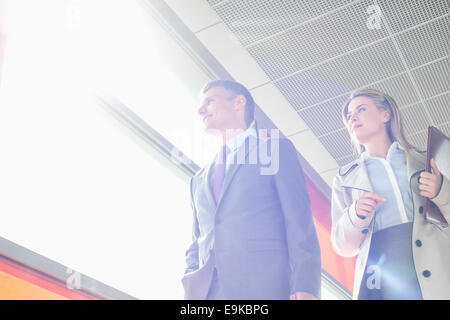 Low angle view of business people walking in railroad station Stock Photo