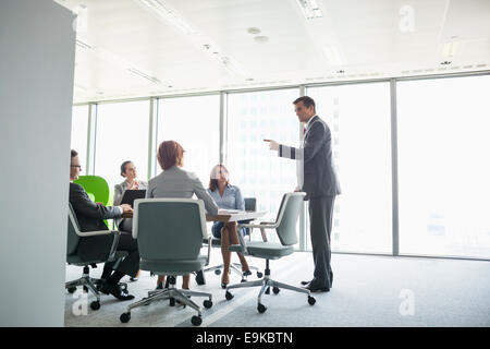 Businessman giving presentation in conference room Stock Photo