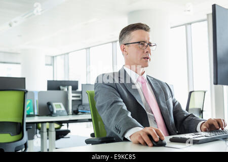 Mature businessman working on computer in office Stock Photo