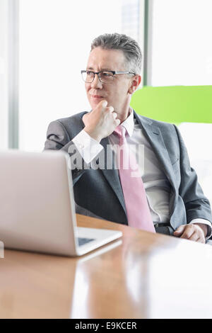 Young businesswoman using copy machine in office Stock Photo