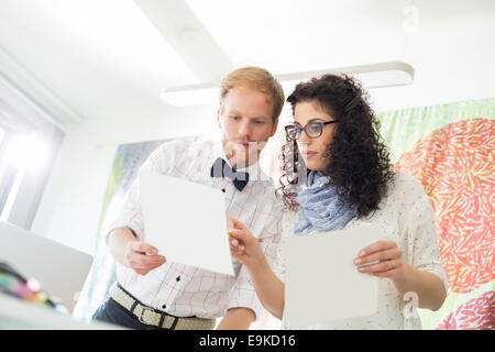 Creative business colleagues discussing over samples in office Stock Photo