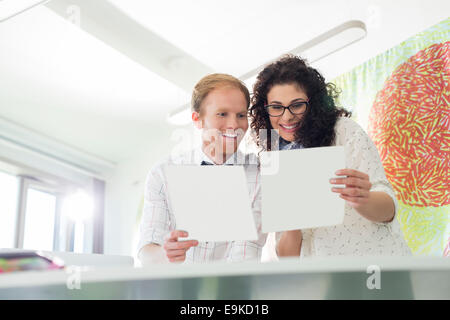 Happy business colleagues examining samples in creative office Stock Photo