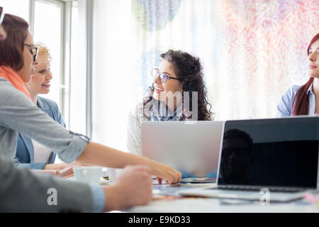 Happy businesspeople discussing during meeting in creative office Stock Photo